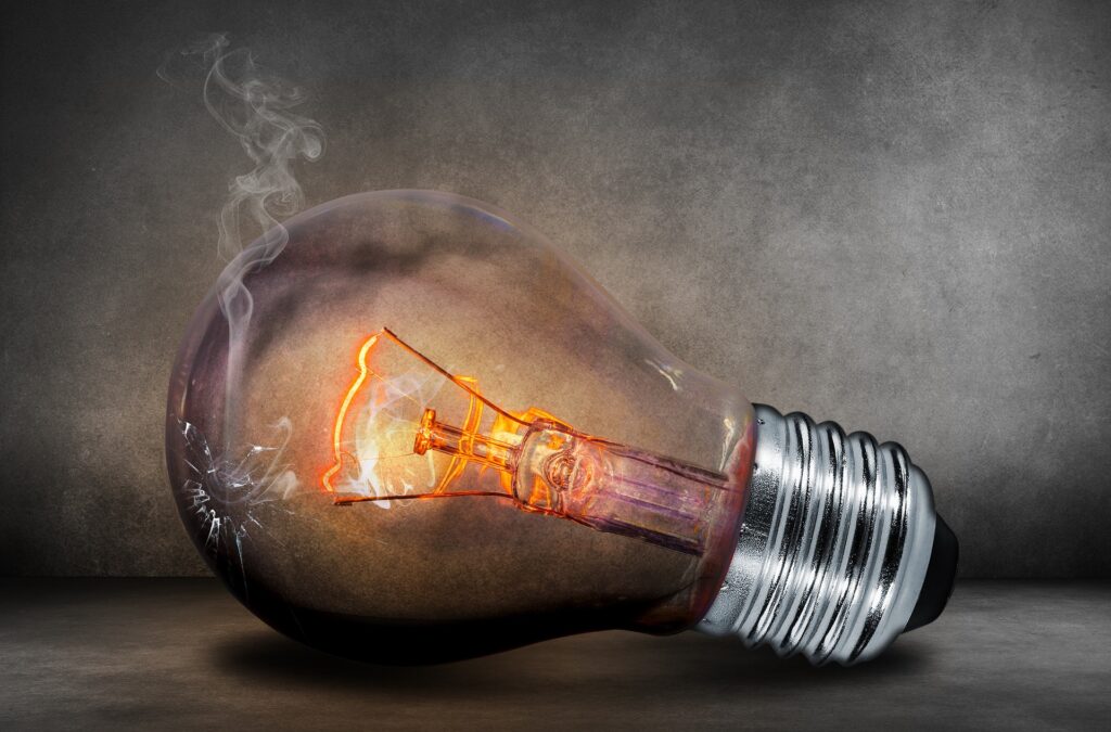Damaged light bulb glowing under pressure, symbolising anxiety, self-doubt, reassurance-seeking, overthinking, and emotional overwhelm.