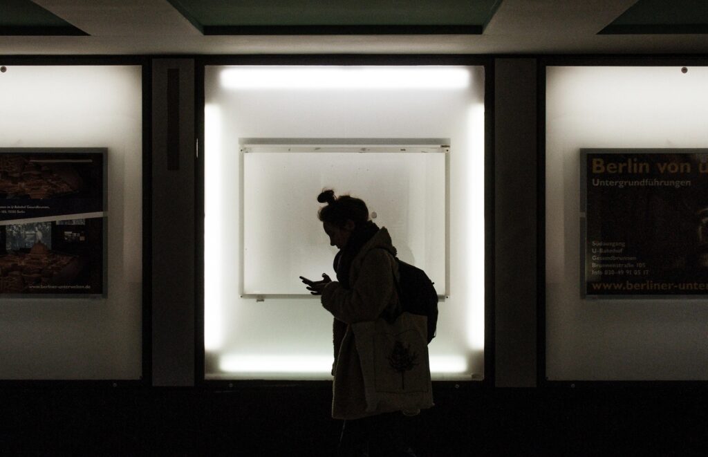 Person looking worried while analysing a text message, representing anxiety, overthinking, fear of rejection, and worrying that others are upset with them.